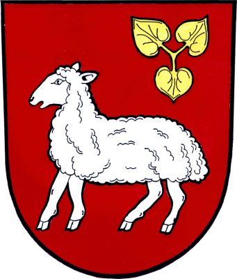 V červeném štítě stříbrná ovce provázená v levém horním rohu zlatým leknínovým trojlistem. Znak Baška