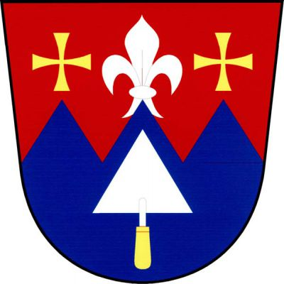 V červeno-modře pětkrát pilovitě děleném štítě nahoře na středním hrotu stříbrná lilie provázená dvěma zlatými tlapatými kříži. Dole vztyčená stříbrná trojúhelníková zednická lžíce se zlatou rukojetí. Znak Dolce