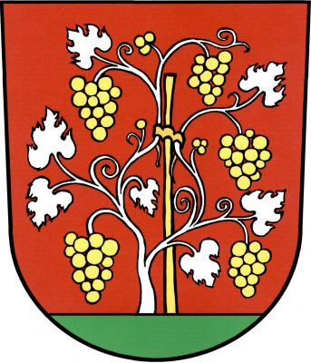 V červeném štítě na zeleném trávníku vyrůstající stříbrný keř vinné révy se zlatými hrozny, přivázaný ke zlatému kolíku. Znak Horní Věstonice