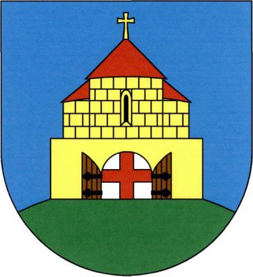 V modrém štítě na zeleném návrší volná zlatá zeď se stříbrnou branou s otevřenými dřevěnými vraty přirozené barvy na černých závěsech, v bráně červený heroldský kříž. Za zdí vyniká rotunda s černým románským oknem, po stranách se zastřešenými apsidami, vše zlaté a kvádrované, střechy červené, prostřední se zlatým křížem. Znak Hradešín