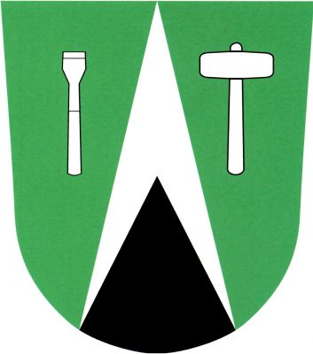 V zeleném štítě stříbrný hrot s černým zkráceným hrotem, provázený vpravo vztyčeným dlátem, vlevo kamenickou palicí, obojí stříbrné. Znak Kacanovy