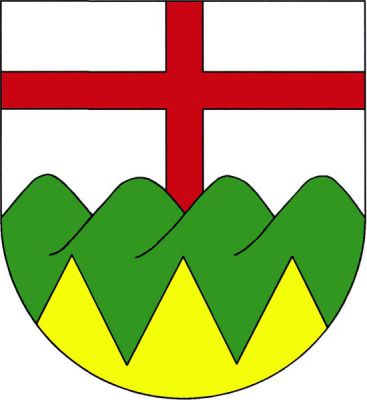 Ve stříbrném štítě nad zlatou, pětkrát pilovitě lomenou, patou ze zeleného čtyřvrší vyrůstající červený heroldský kříž. Znak Karlovice