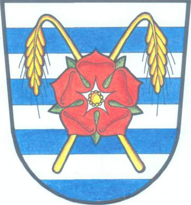 V sedmkrát stříbrno - modře děleném štítě červená růže se zlatým semeníkem a zelenými kališními lístky, podložená zkříženými svěšenými zlatými obilnými klasy. Znak Neplachov
