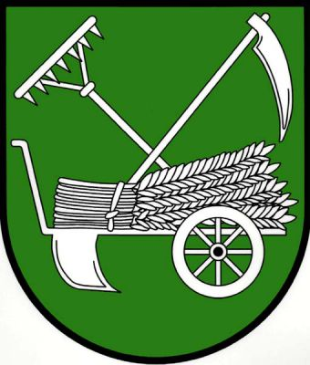 V zeleném štítě doleva obrácené ruchadlo, na něm položený snop, za ním zkřížené hrábě a kosa, vše stříbrné. Znak Semčice