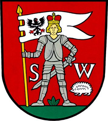 V červeném štítě na zeleném trávníku stojící sv. Václav ve zbroji s knížecí korunou na hlavě, v pravé ruce drží na zlaté žerdi stříbrný praporec - vlaštovčí ocas s černou orlicí v žerďové části. Postava je provázena stříbrnými majuskulními písmeny S W, pod písmenem W stříbrný ježek. Znak Stonařov