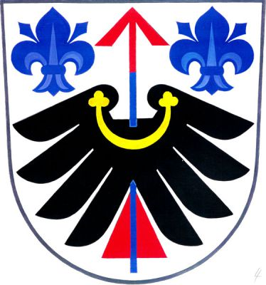 Ve stříbrném štítě černé rozložené křídlo, pery dolů, se zlatým perizoniem, vzhůru prostřelené modrým šípem s červeným opeřením a hrotem, provázeným modrými liliemi. Znak Střelná