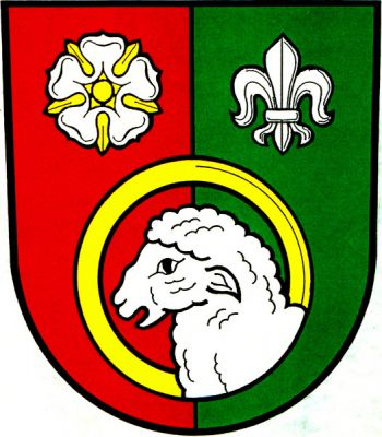 V červeno-zeleně polceném štítě stříbrná hlava beránka se zlatou svatozáří v podobě mezikruží, provázená nahoře vpravo stříbrnou růží se zlatým semeníkem a kališními lístky, vlevo stříbrnou lilií. Znak Těškovice