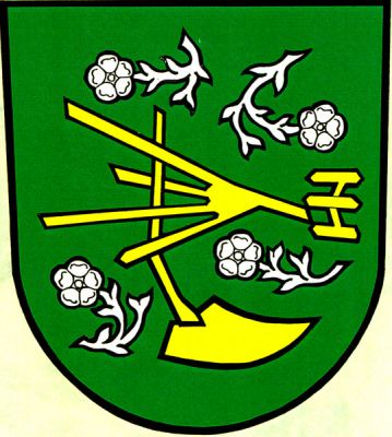 V zeleném štítě zlatý doleva obrácený pluh bez kol provázený čtyřmi stříbrnými květy na prohnutých a odvrácených stoncích. Znak Tísek