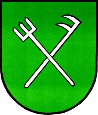 V zeleném štítě zkřížené stříbrné vidle a kopáč se dvěma zuby. Znak Tvarožná