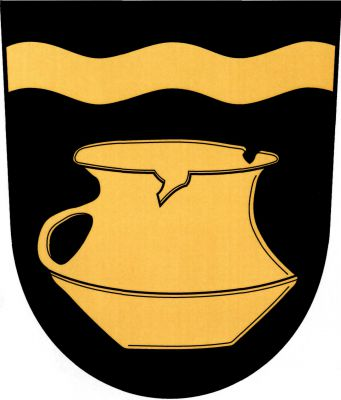 V černém štítě pod zvýšeným vlnitým břevnem únětický koflík, vše zlaté. Znak Únětice
