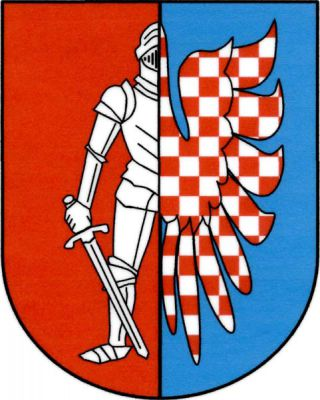 V červeno-modře polceném štítě vpravo vyniká půl ozbrojence v úplné plátové zbroji s postaveným mečem v pravici, vše stříbrné, vlevo vyniká stříbrno-červeně šachované křídlo. Znak Všesulov